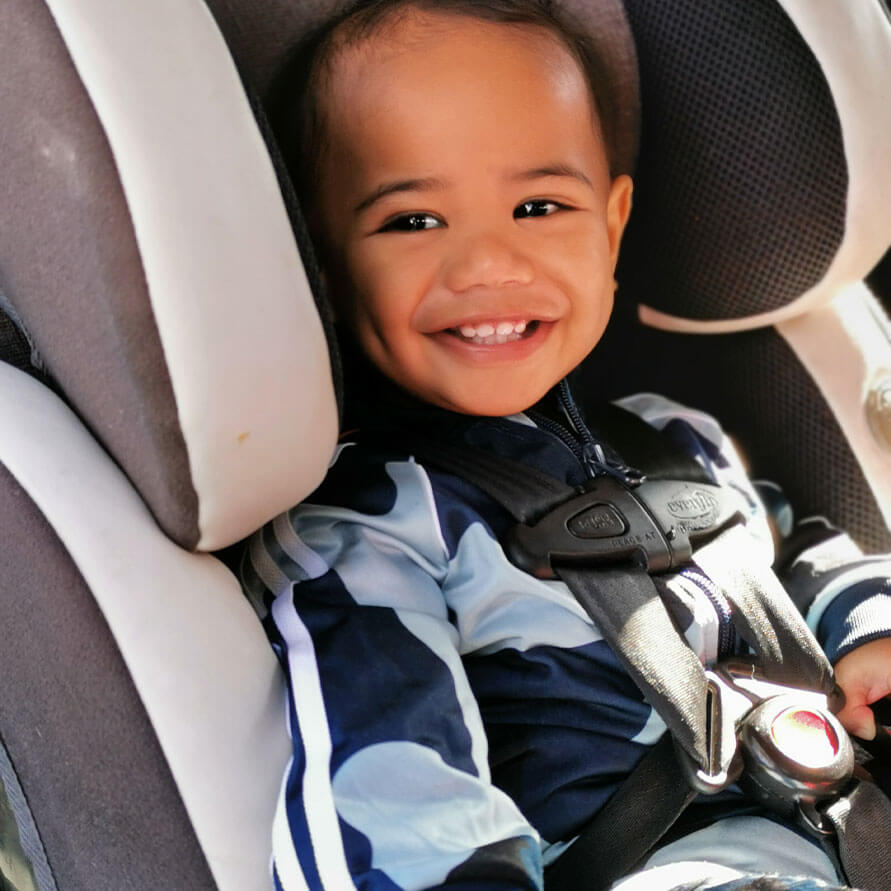 12 month old in rear-facing child restraint in New Zealand.  Evenflo Symphony.  US standard child restraint.