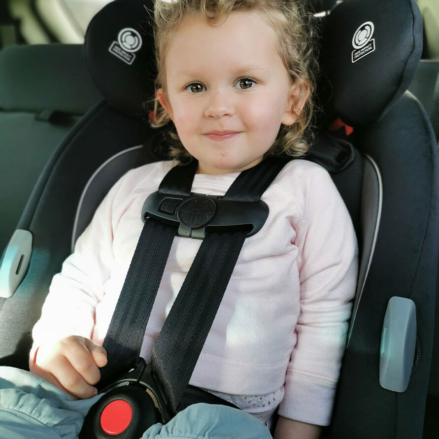 3 year old in car seat in New Zealand -right