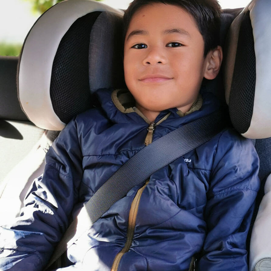 6 year old in Evenflo Symphony US standard child restraint converted to booster seat.  In New Zealand.  